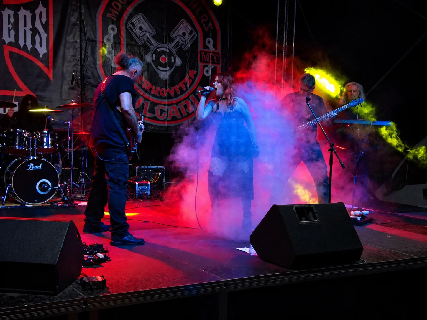 Entropy Devine performing on stage amid colourful lights and smoke